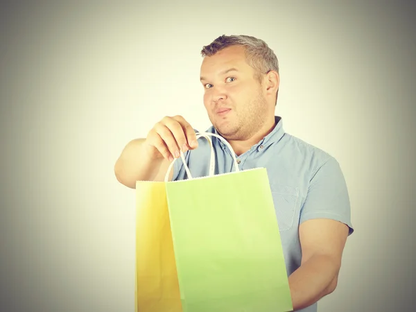 Caucasian man fat,  with colorful shopping paper bags