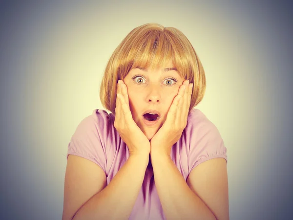 Close-up portrait of a young , scared women. She opened her mout