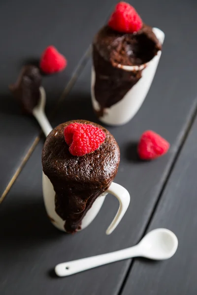 Chocolate brownie with fresh raspberries in a mug