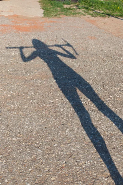 Shadow of woman with pick