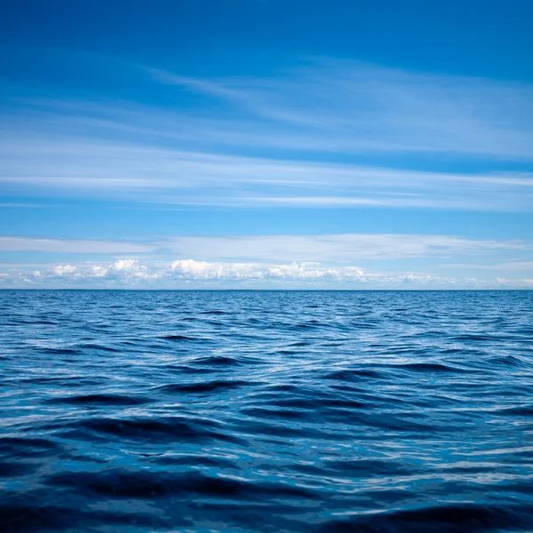 Blue sky reflecting in rippled lake surface