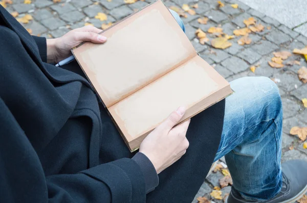 Man sitting with opened empty notebook of recycled paper