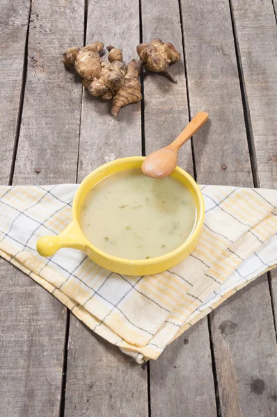 Served soup of Jerusalem artichoke in yellow bowl