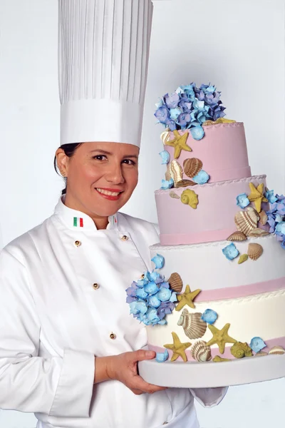 Woman holding a big cake.