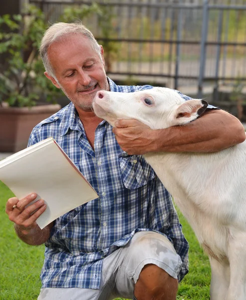 Farmer with baby cow