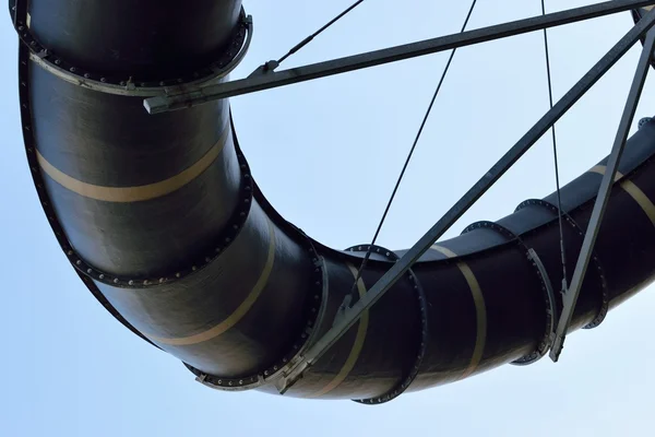 Aqua park tubes in front of blue sky