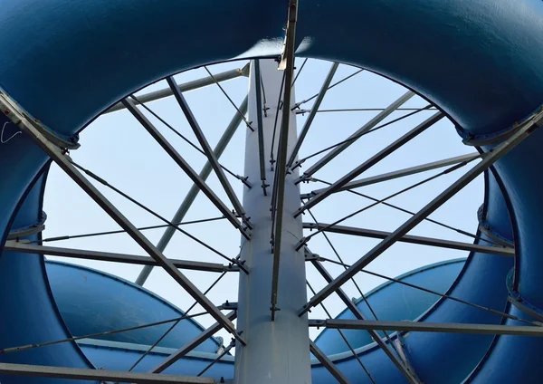 Aqua park tubes in front of blue sky