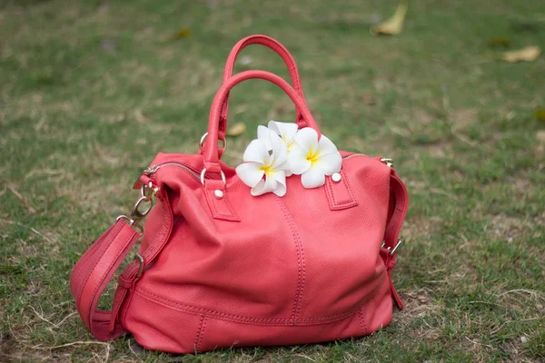 Bag of coral color with white flowers