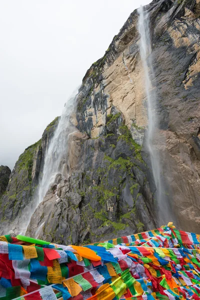 YUBENG, CHINA - Aug 10 2014: Holy Waterfall at Yubeng Village. a famous landscape in the Tibetan village of Deqin, Yunnan, China.