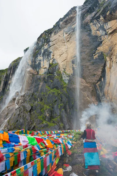 YUBENG, CHINA - Aug 10 2014: Holy Waterfall at Yubeng Village. a famous landscape in the Tibetan village of Deqin, Yunnan, China.