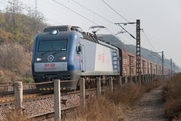 HENAN, CHINA - NOV 19 2014: China Railways HXD3 electric locomotive in Luoyang, Henan, China. The locomotive is designed for hauling 5000t freight trains.