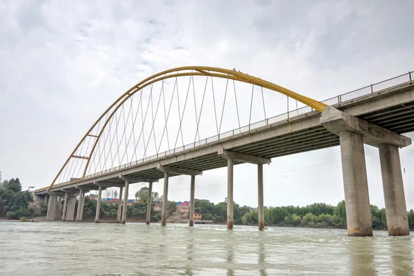 GUIDE, CHINA - Jun 27 2014: The yellow river big bridge(Huanghe Qing Daqiao). a famous landmark in the ancient city of Guide, Qinghai, China.