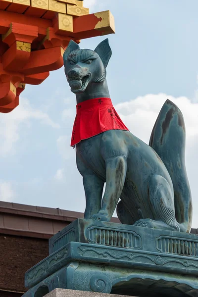 KYOTO, JAPAN - Jan 11 2015: statues of foxes at Fushimi Inari-taisha Shrine. a famous shrine in the Ancient city of Kyoto, Japan.