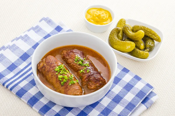 Two roulades beef in bowl with sauce