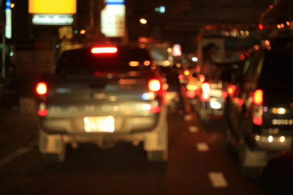 Blurred bokeh of car in city at night