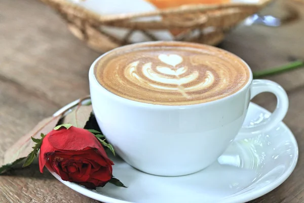 Vintage latte art coffee and red rose