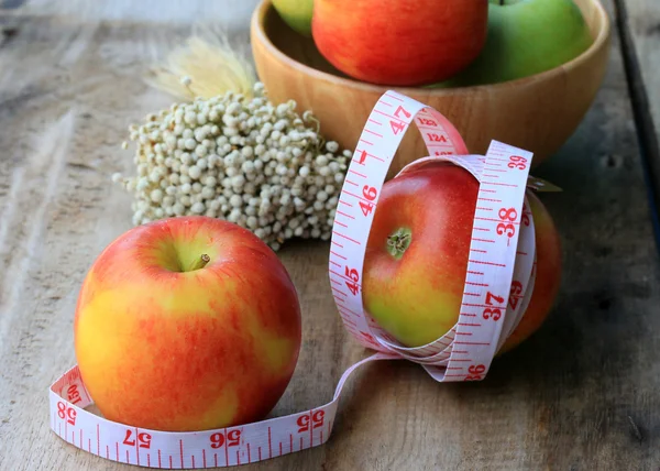Measure tape and apple