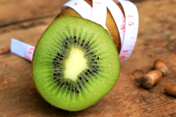 Fresh kiwi fruit and tape measure