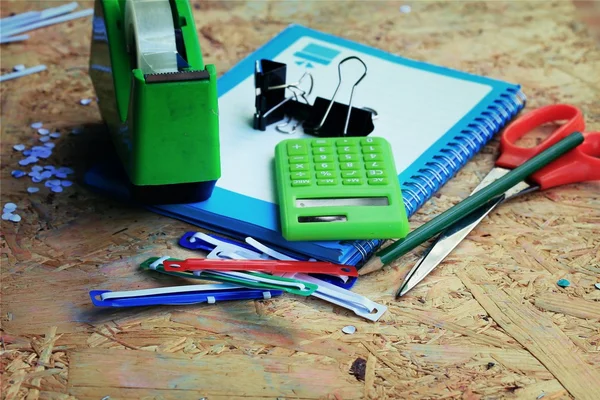 Mix book and calculator, stapler, tape, paper punch, pencil