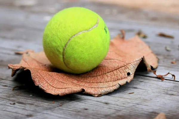 Tennis ball on wooden
