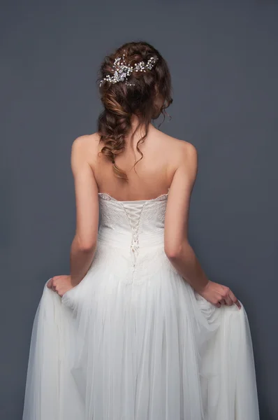 Bridal fashion. Brunette bride view from the back.