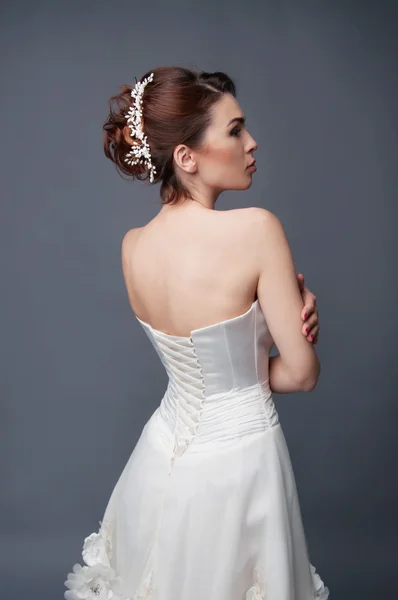 Bridal hairstyle. Brunette with curly hair and beaded headpiece.