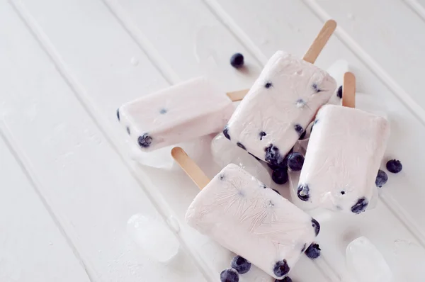 Ice popsicles with yogurt and blueberries in ice lolly mold