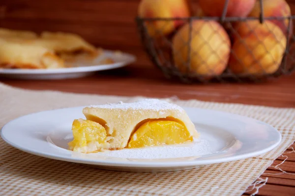 Peach caramel turnover pie sprinkled with sugar powder