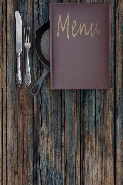 Vintage restaurant menu on a rustic wood background