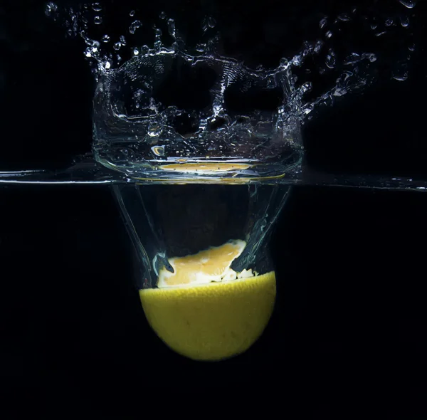 Lemon falling in water