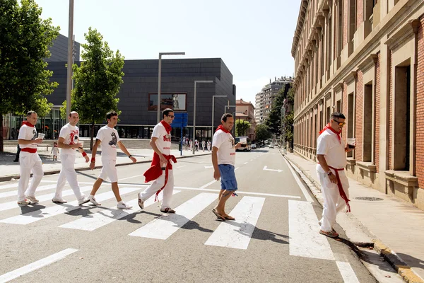 Spain Navarra Pamplona 10 July 2015 S Firmino fiesta guys in typical dress for the feast walking in the street