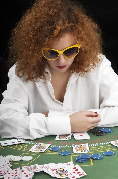 Girl with glasses playing cards