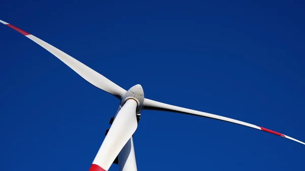 Wind turbine closeup on the blue sky