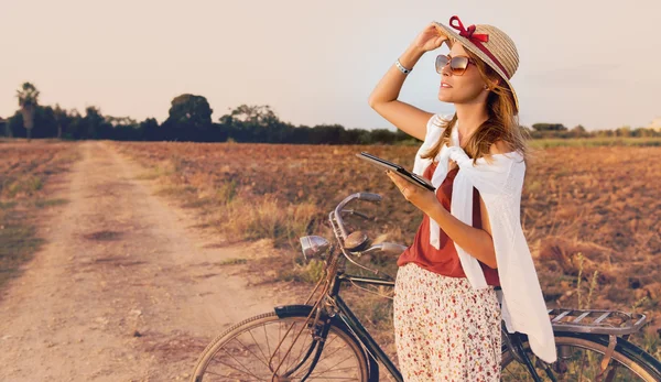 Young woman with bike in  countryside