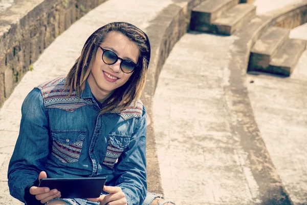 Smiling young man with tablet Concept of new trends retro nostal