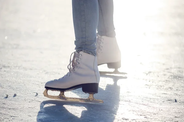 Closeup of young girl on the  fugure skates outdoor in sunny spring day