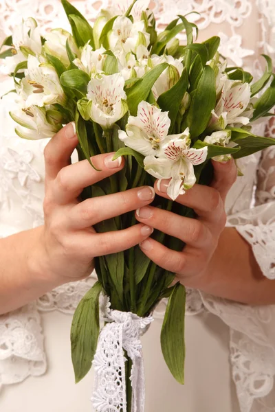 Brides hands with flowers