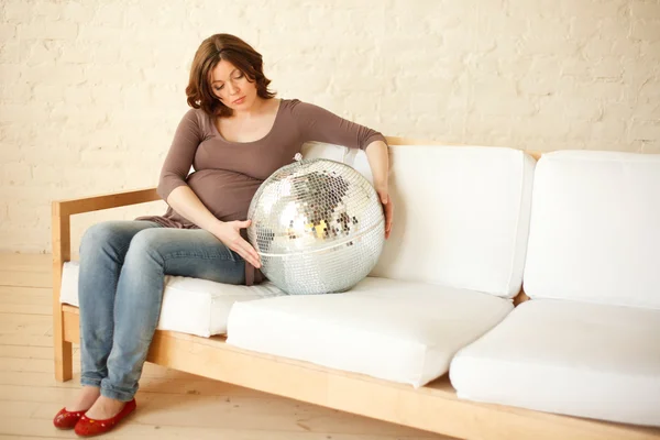 Pregnant woman with big silver ball