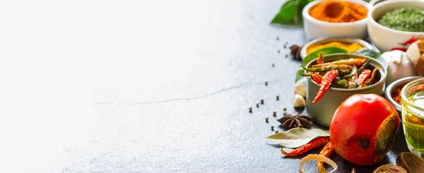 Mixed spices and herbs on background.