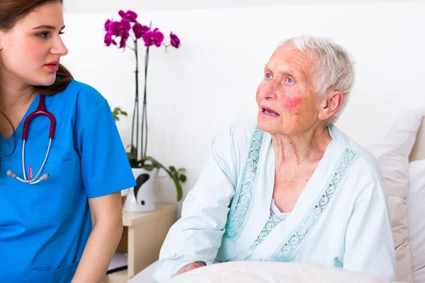 Nurse with elderly woman patient