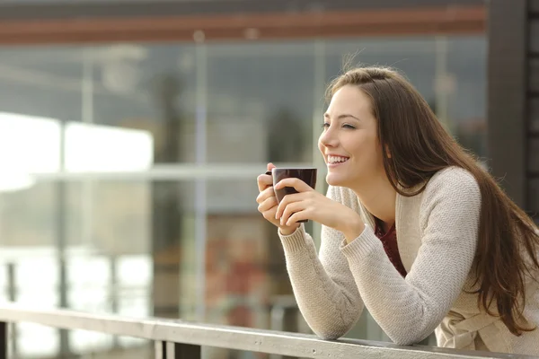 Happy woman thinking at breakfast on vacation