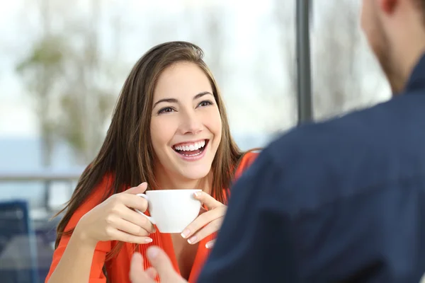 Happy woman dating in a coffee shop