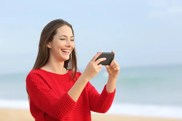 Girl laughing watching videos in smart phone