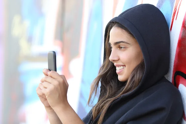 Skater style teen girl reading happy her smart phone
