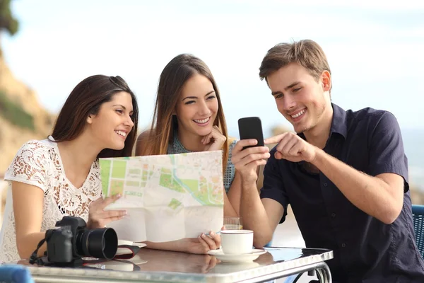 Group of young tourist friends consulting gps map in a smart phone