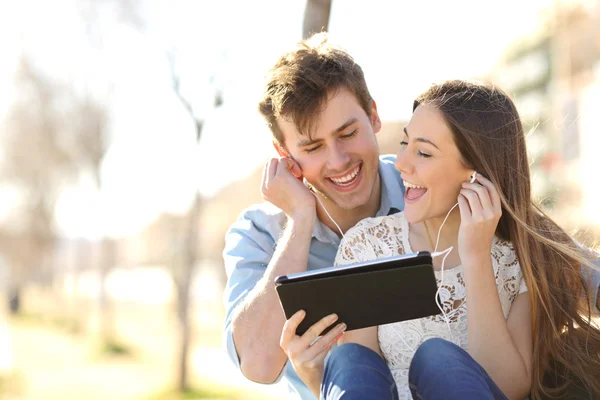 Couple sharing music and singing with a tablet