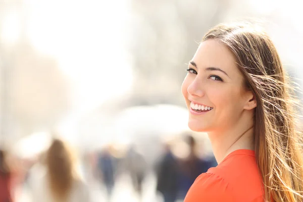 Beauty woman with perfect smile and white teeth on the street