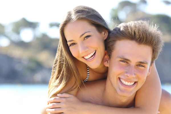 Couple with perfect smile posing on the beach