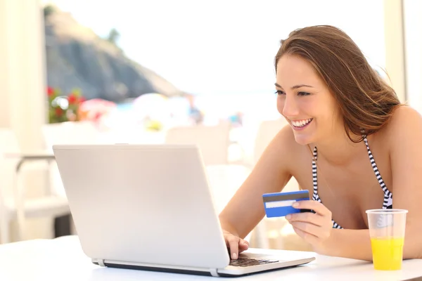 Woman buying online on vacations