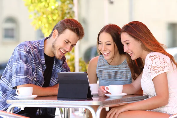 Three friends watching tv or social media in a tablet